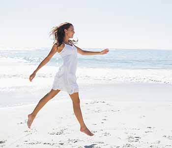 Lady having a slim body , walking on the beach